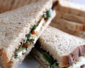 Standard lunch box with deli sandwich, apple, and cookie by Canuel Caterers